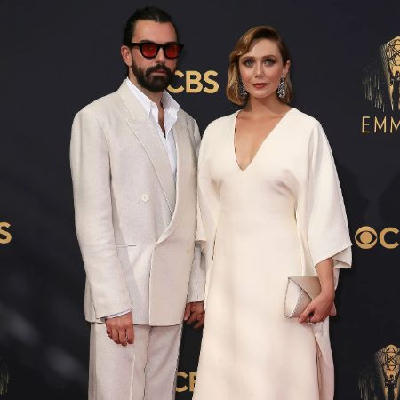 Elizabeth Olsen attends an award show with her husband, Robbie Arnett